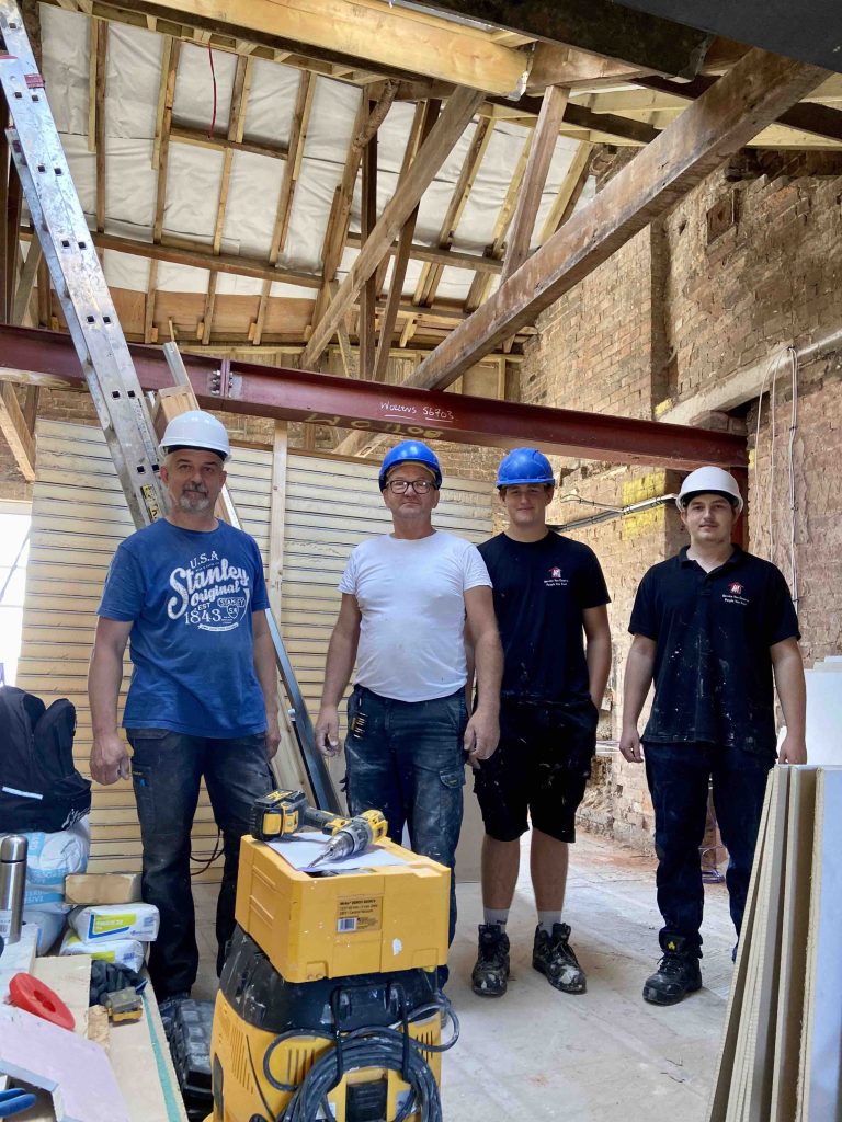 Photo of four people from the Mario Maintenance Service Team working at The Engine Room project, which is part of the Bridgwater Town Deal