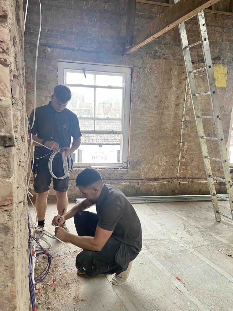 Photo of two people from Paul Hill Technical Services working on The Engine Room project, which is part of the Bridgwater Town Deal